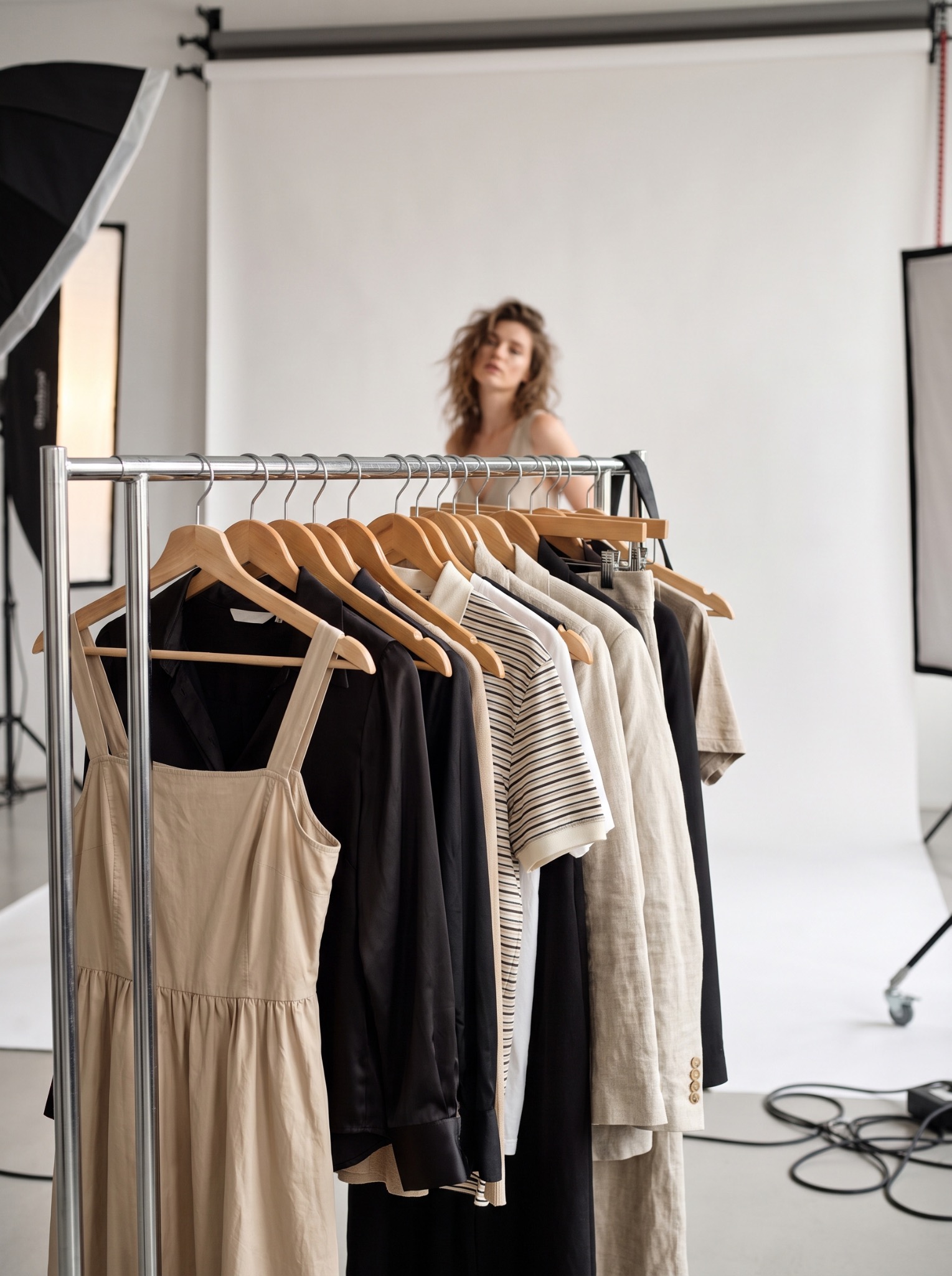 Wardrobe options arranged on a clothing rack in a professional photography studio